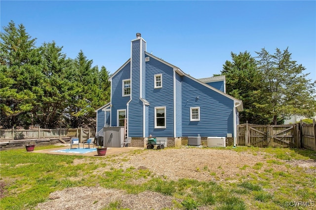 1724 Villageway Dr, Henrico, VA 23229 - back of house featuring a patio, cooling unit, a fenced backyard, a chimney, and a gate