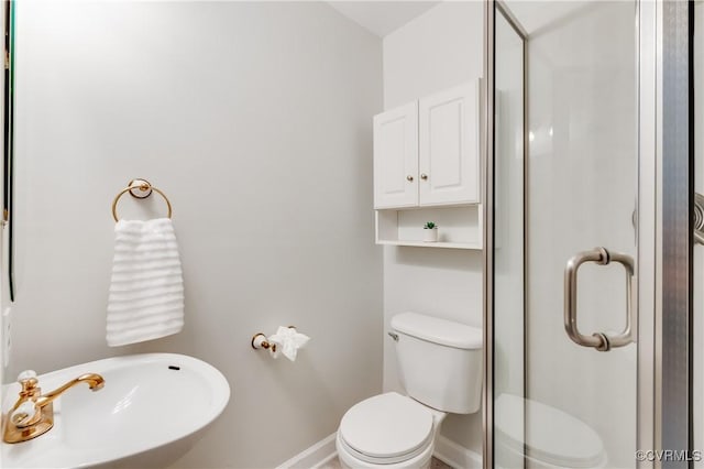 7611 Comanche Dr, Richmond, VA 23225 - bathroom featuring toilet, a sink, baseboards, and a stall shower