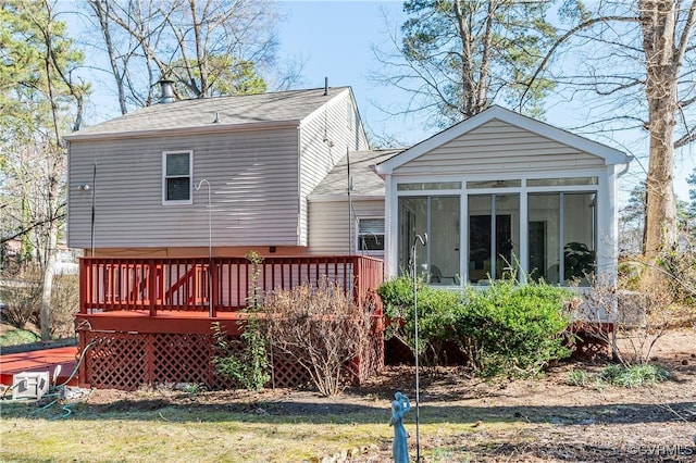 7611 Comanche Dr, Richmond, VA 23225 - back of property featuring a sunroom, a wooden deck, and roof with shingles