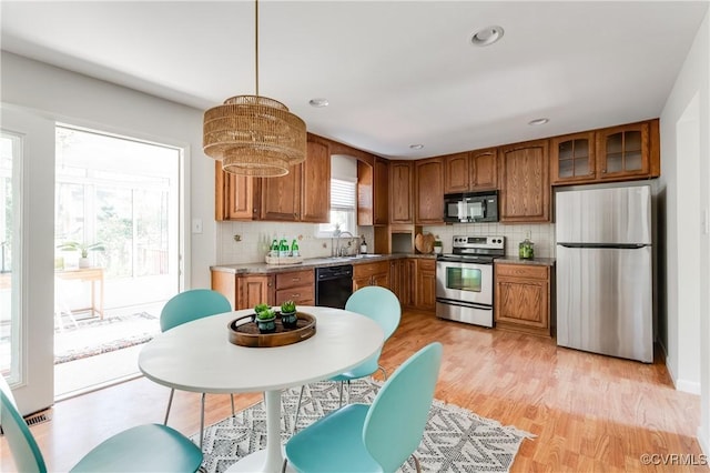 7611 Comanche Dr, Richmond, VA 23225 - kitchen featuring black appliances, brown cabinets, decorative backsplash, and recessed lighting