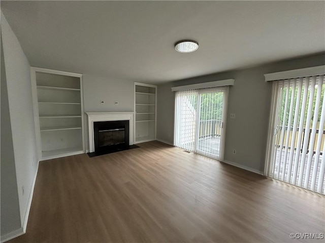 7821 Breaker Point Ct, Chesterfield, VA 23832 - unfurnished living room featuring wood finished floors, built in shelves, baseboards, and a fireplace with flush hearth