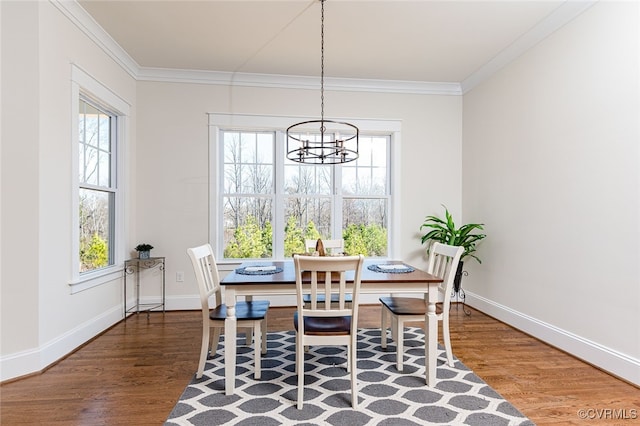 1555 Smokey Ridge Rd, Maidens, VA 23102 - dining space featuring wood finished floors, a chandelier, healthy amount of natural light, crown molding, and baseboards
