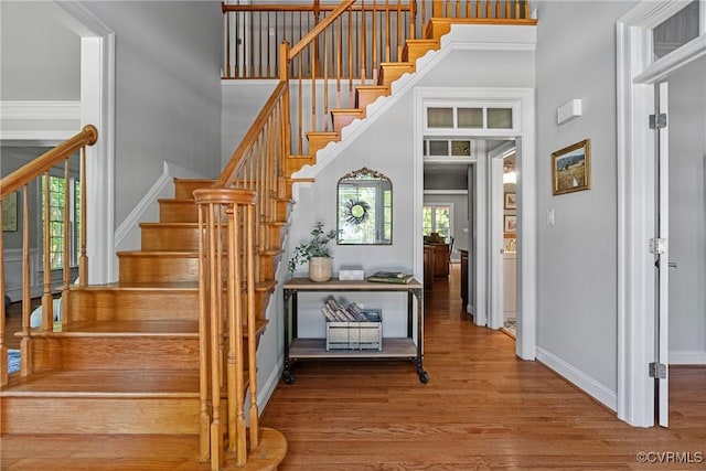 14136 Rigney Dr, Midlothian, VA 23113 - stairs featuring a towering ceiling, wood finished floors, and baseboards