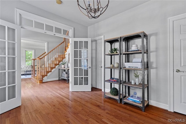 14136 Rigney Dr, Midlothian, VA 23113 - empty room with french doors, a chandelier, wood finished floors, stairway, and baseboards