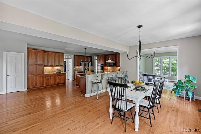 14136 Rigney Dr, Midlothian, VA 23113 - dining room featuring a chandelier, light wood finished floors, and baseboards