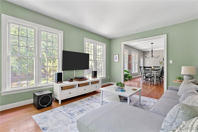 14136 Rigney Dr, Midlothian, VA 23113 - living area with healthy amount of natural light, wood finished floors, a chandelier, and baseboards