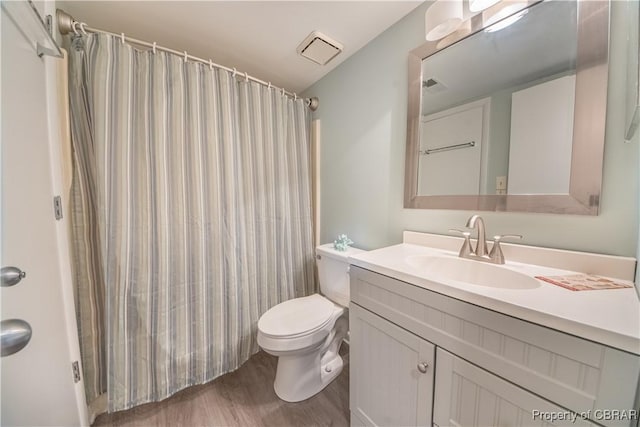 54 Villa Ridge Dr Unit C, Hartfield, VA 23071 - bathroom featuring vanity, wood finished floors, toilet, and curtained shower