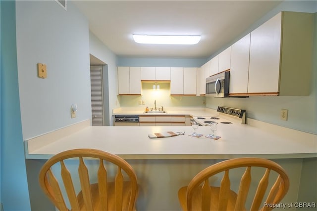54 Villa Ridge Dr Unit C, Hartfield, VA 23071 - kitchen featuring electric range oven, a sink, stainless steel microwave, light countertops, and dishwasher