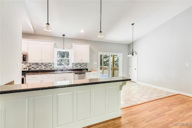 6180 Emmaus Church Rd, Providence Forge, VA 23140 - kitchen featuring stainless steel dishwasher, a sink, decorative backsplash, white cabinets, and light wood finished floors