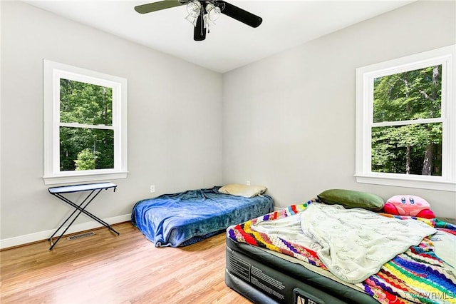 6180 Emmaus Church Rd, Providence Forge, VA 23140 - bedroom with multiple windows, wood finished floors, a ceiling fan, and baseboards