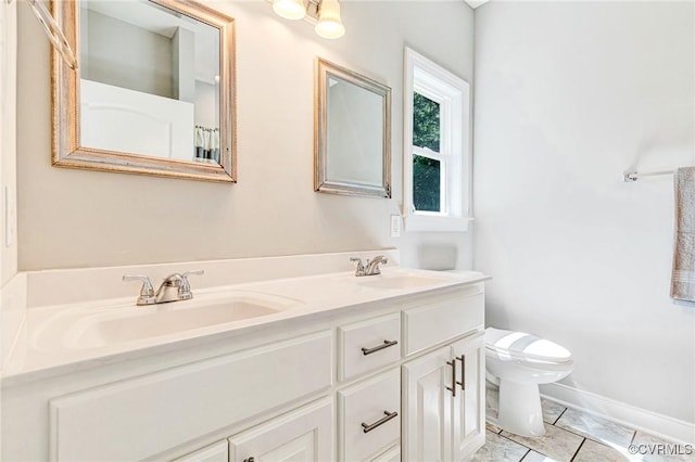 6180 Emmaus Church Rd, Providence Forge, VA 23140 - bathroom featuring double vanity, toilet, and baseboards