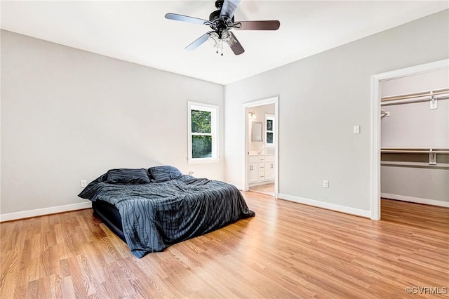 6180 Emmaus Church Rd, Providence Forge, VA 23140 - bedroom featuring light wood finished floors, baseboards, a walk in closet, ceiling fan, and connected bathroom