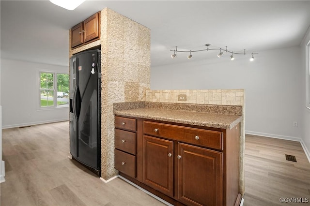 9901 Husting Ct, Chesterfield, VA 23832 - kitchen featuring black fridge, light wood-type flooring, baseboards, and brown cabinetry