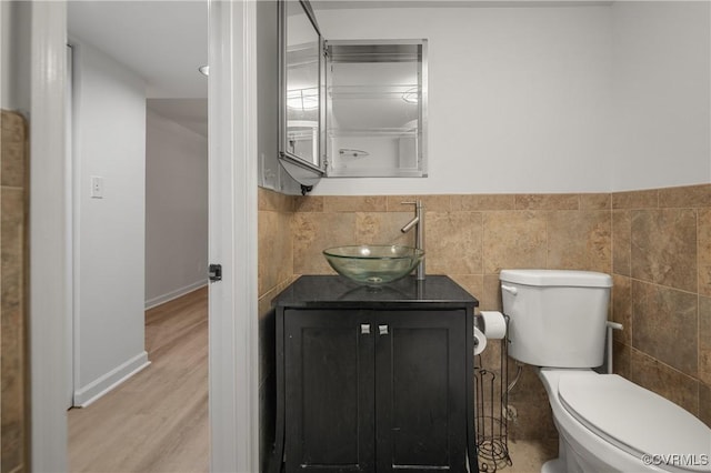 9901 Husting Ct, Chesterfield, VA 23832 - bathroom with toilet, vanity, tile walls, wood finished floors, and a wainscoted wall
