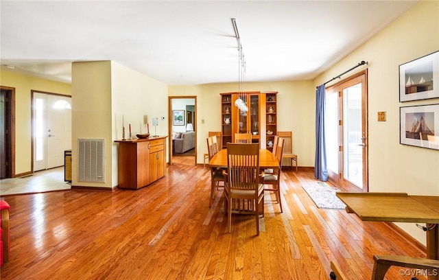 1412 Darrell Dr, Midlothian, VA 23114 - dining room with rail lighting, light wood finished floors, and baseboards