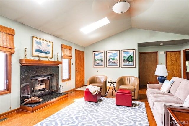 1412 Darrell Dr, Midlothian, VA 23114 - living area with wood finished floors, vaulted ceiling, baseboards, a skylight, and a fireplace