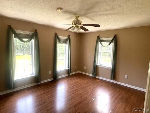 22290 Butterwood Rd, Dinwiddie, VA 23803 - spare room featuring a ceiling fan, a textured ceiling, dark wood-style flooring, and baseboards