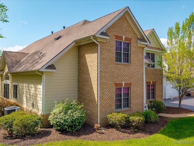 442 Dunlin Ct, Midlothian, VA 23114 - view of side of property with cooling unit, brick siding, and a shingled roof