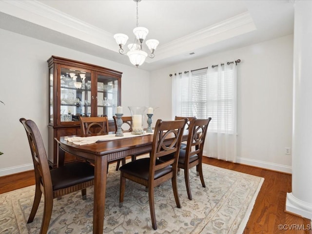 442 Dunlin Ct, Midlothian, VA 23114 - dining space featuring plenty of natural light, a chandelier, ornamental molding, a raised ceiling, and wood finished floors