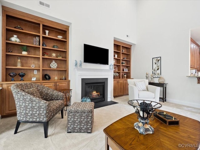 442 Dunlin Ct, Midlothian, VA 23114 - living room featuring built in shelves, a fireplace with flush hearth, light carpet, a high ceiling, and baseboards