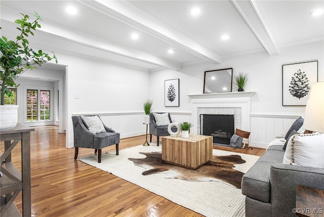 13531 W Salisbury Rd, Midlothian, VA 23113 - living room featuring beamed ceiling, light wood finished floors, a fireplace, a wainscoted wall, and recessed lighting