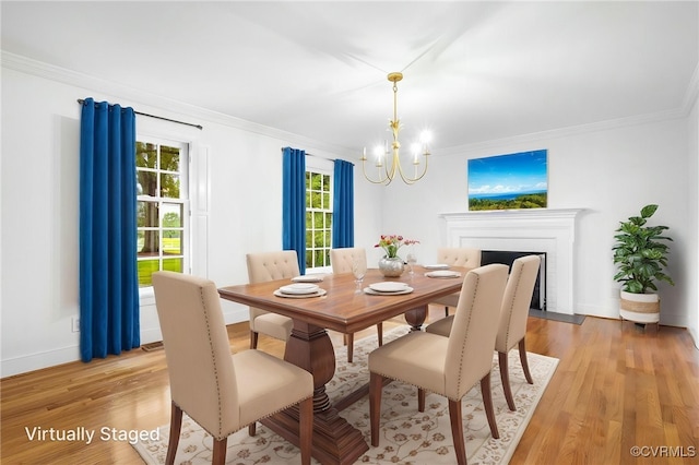 13531 W Salisbury Rd, Midlothian, VA 23113 - dining area with a chandelier, crown molding, light wood finished floors, baseboards, and a fireplace with flush hearth