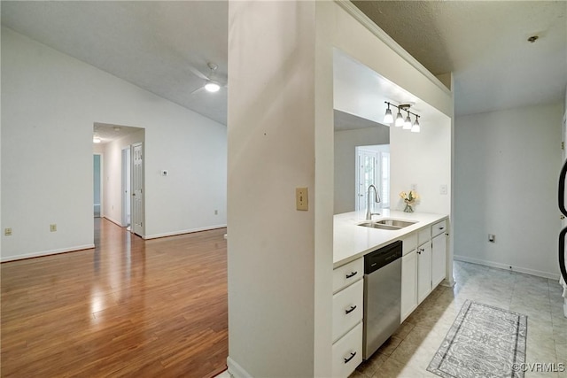 10205 Wolfe Manor Ct Unit 1012, Glen Allen, VA 23060 - kitchen featuring dishwasher, a sink, white cabinets, light countertops, and vaulted ceiling