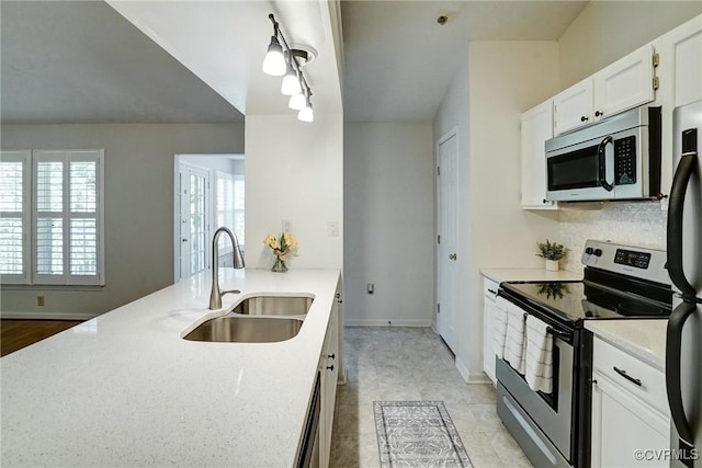 10205 Wolfe Manor Ct Unit 1012, Glen Allen, VA 23060 - kitchen featuring appliances with stainless steel finishes, a sink, white cabinetry, baseboards, and light stone countertops