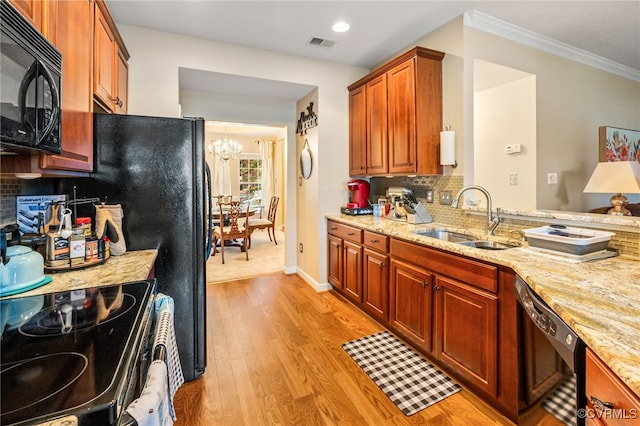 6049 Eagles Crest Dr, Chesterfield, VA 23832 - kitchen featuring black appliances, a sink, light wood-style floors, decorative backsplash, and ornamental molding