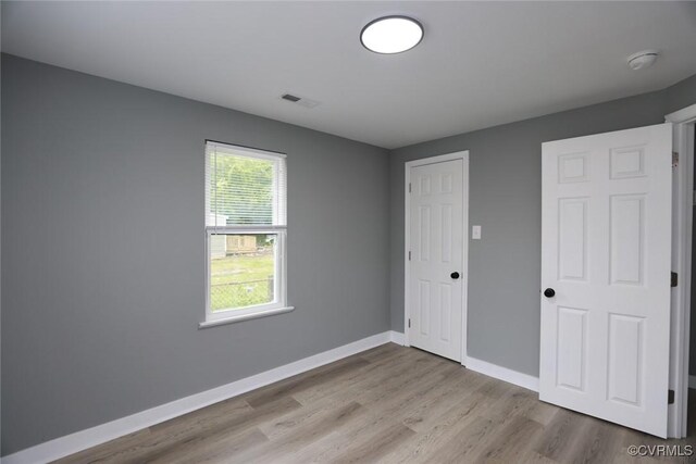 935 Wilcox St, Petersburg, VA 23803 - unfurnished bedroom featuring wood finished floors, baseboards, and a closet