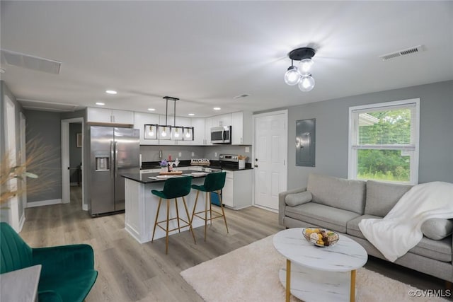 935 Wilcox St, Petersburg, VA 23803 - living area with light wood-style flooring, recessed lighting, and baseboards