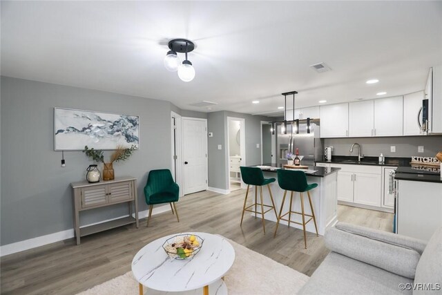 935 Wilcox St, Petersburg, VA 23803 - kitchen with appliances with stainless steel finishes, dark countertops, a sink, a center island, and baseboards