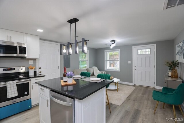 935 Wilcox St, Petersburg, VA 23803 - kitchen featuring stainless steel appliances, white cabinetry, light wood-style flooring, dark countertops, and recessed lighting
