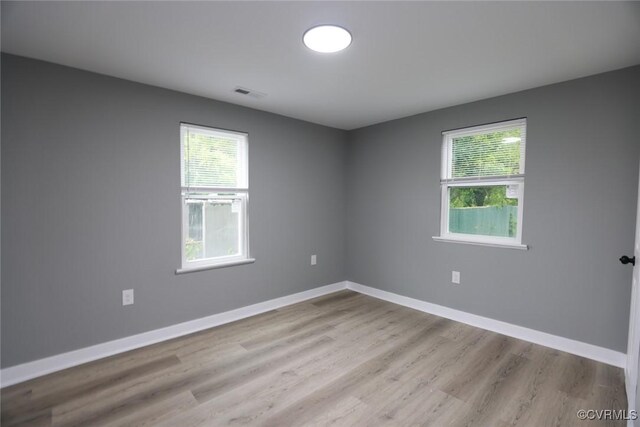 935 Wilcox St, Petersburg, VA 23803 - unfurnished room featuring healthy amount of natural light, wood finished floors, and baseboards