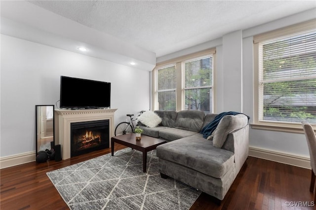 6 N 6th St Unit U2B, Richmond, VA 23219 - living room with wood finished floors, a warm lit fireplace, baseboards, a textured ceiling, and recessed lighting