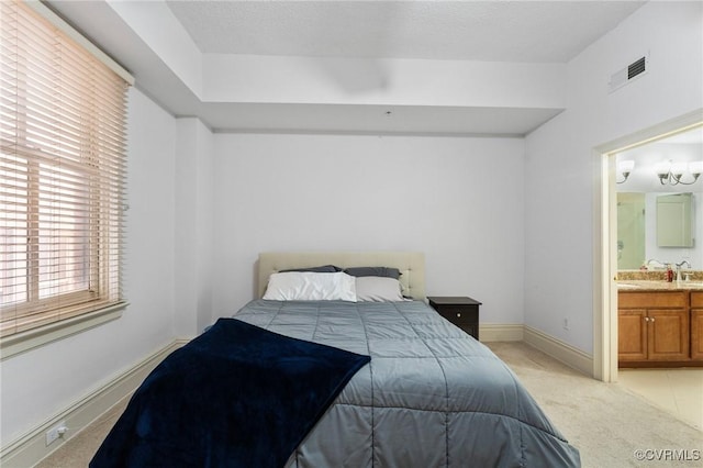 6 N 6th St Unit U2B, Richmond, VA 23219 - bedroom with light carpet, connected bathroom, and baseboards