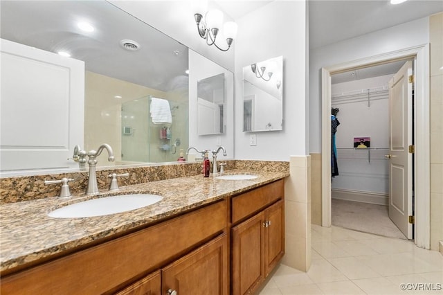 6 N 6th St Unit U2B, Richmond, VA 23219 - bathroom featuring a stall shower, double vanity, tile patterned floors, and a spacious closet