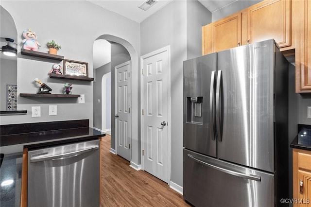 1753 Rose Mill Cir, Midlothian, VA 23112 - kitchen with stainless steel appliances, dark countertops, open shelves, wood finished floors, and arched walkways