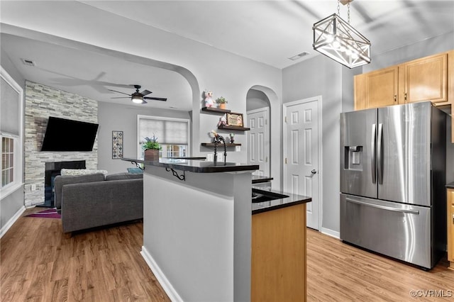 1753 Rose Mill Cir, Midlothian, VA 23112 - kitchen featuring stainless steel refrigerator with ice dispenser, dark countertops, arched walkways, and healthy amount of natural light