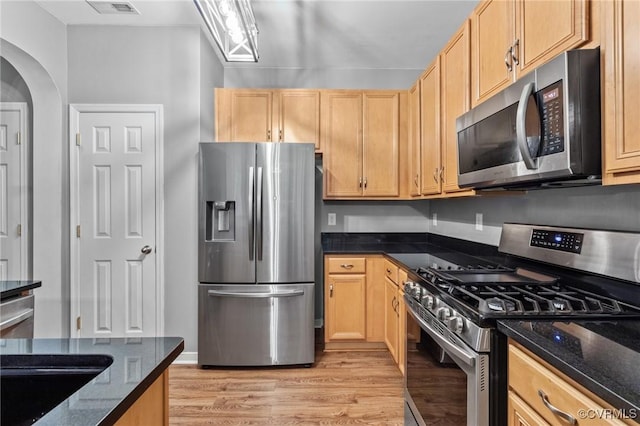 1753 Rose Mill Cir, Midlothian, VA 23112 - kitchen featuring stainless steel appliances, light wood-style floors, dark stone countertops, and light brown cabinetry