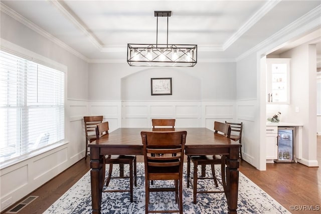 14104 Waters Edge Cir, Midlothian, VA 23112 - dining space with dark wood-style floors, a tray ceiling, a decorative wall, beverage cooler, and a wainscoted wall