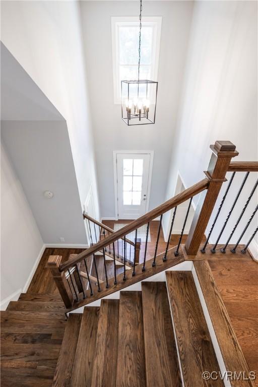14104 Waters Edge Cir, Midlothian, VA 23112 - stairs with baseboards, a chandelier, wood finished floors, and a high ceiling