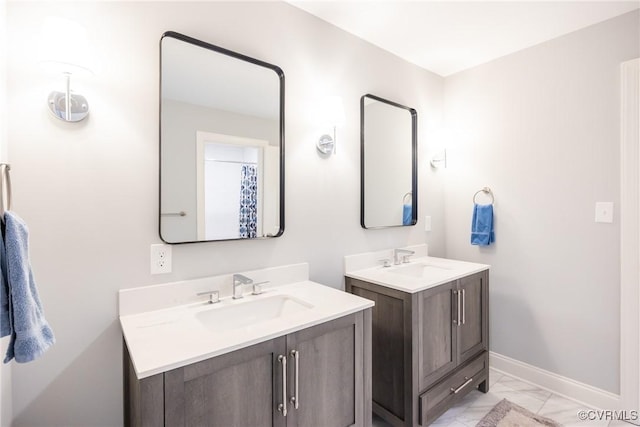 14104 Waters Edge Cir, Midlothian, VA 23112 - bathroom featuring marble look tile flooring, two vanities, and baseboards