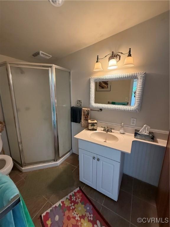 1686 Locust Grove Rd, Topping, VA 23169 - full bath with tile patterned floors, toilet, a shower stall, and vanity