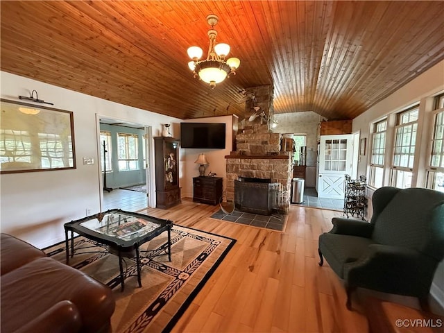 1686 Locust Grove Rd, Topping, VA 23169 - living room featuring lofted ceiling, wood ceiling, a chandelier, a fireplace, and light wood-style flooring