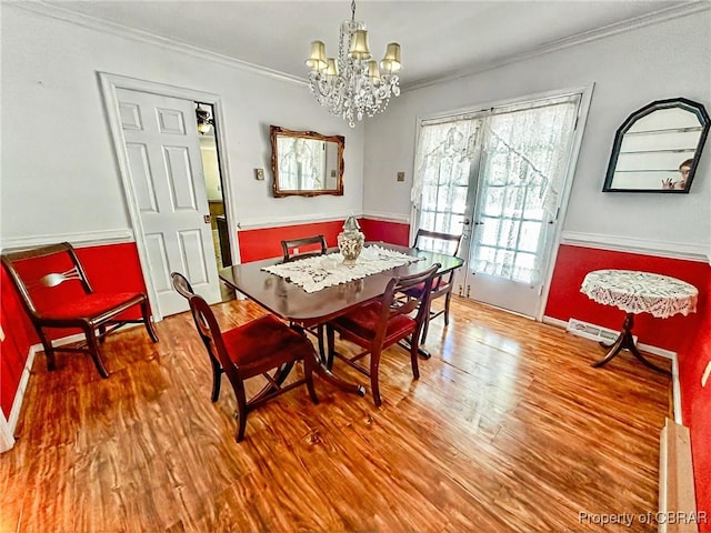 402 N Ivy Ave, Highland Springs, VA 23075 - dining room featuring ornamental molding, wood finished floors, and a chandelier