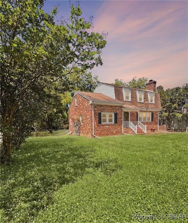 402 N Ivy Ave, Highland Springs, VA 23075 - view of front of home with a yard, a chimney, and brick siding
