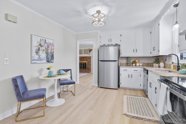 3511 Respess Rd, Midlothian, VA 23112 - kitchen featuring appliances with stainless steel finishes, baseboards, a sink, white cabinets, and decorative backsplash