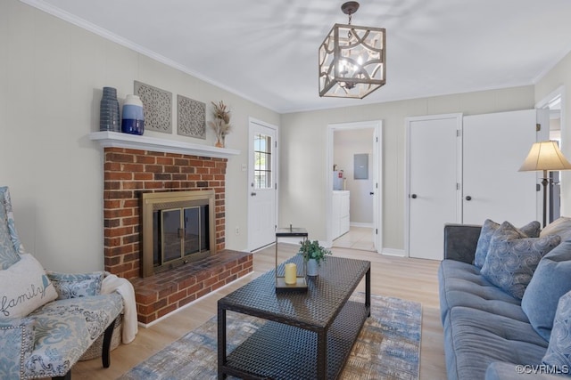 3511 Respess Rd, Midlothian, VA 23112 - living room featuring a chandelier, a brick fireplace, wood finished floors, crown molding, and electric panel
