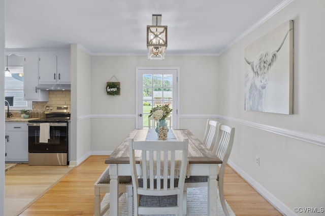 3511 Respess Rd, Midlothian, VA 23112 - dining room with light wood-style floors, crown molding, and baseboards
